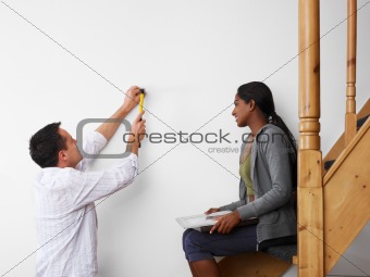man and woman doing diy work at home
