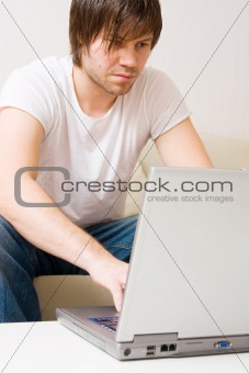 young man home with laptop