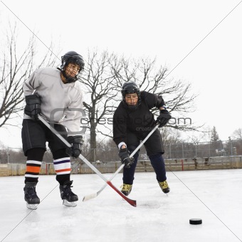 Boys playing ice hockey.