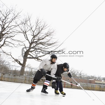 Boys playing winter sport.
