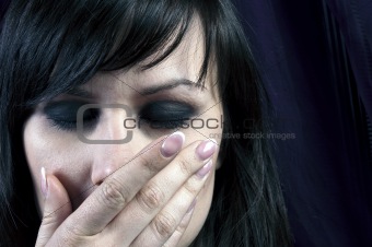 Young girl covering her mouth with her hand in black and white