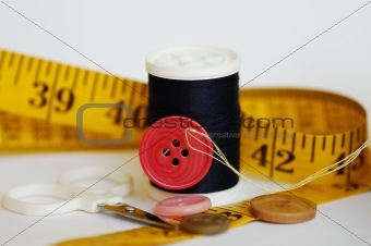 Some sewing tools such as threads, needles, buttons, and scissors