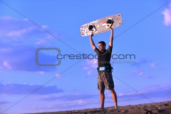 Portrait of a young  kitsurf  man at beach on sunset