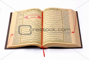The Holy Koran opened and isolated on white background
