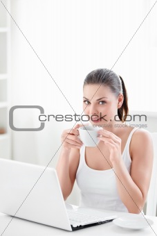 Woman with coffee and laptop