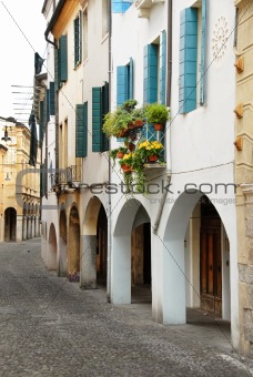 Street in Italy, terrace with flowerpots