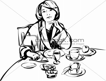 girl in a bathrobe at breakfast table