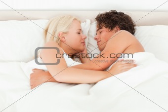 Couple sleeping facing each other