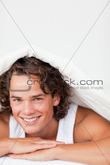 Portrait of a man under a duvet