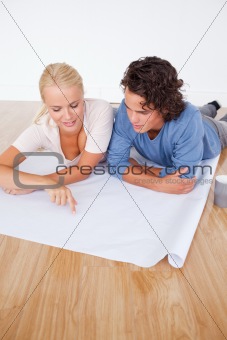 Portrait of a woman showing a point on a plan to her boyfriend
