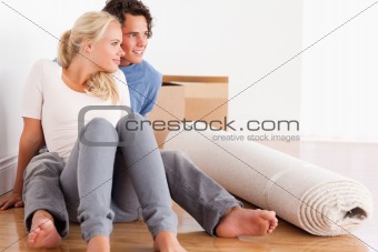 Lovely couple sitting on the floor 