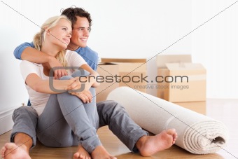 Smiling couple sitting on the floor