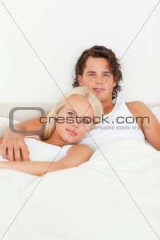 Cute couple lying on a bed