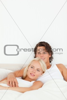 Portrait of a happy couple lying on a bed