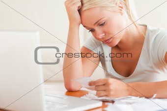 Stressed blond woman doing paperwork
