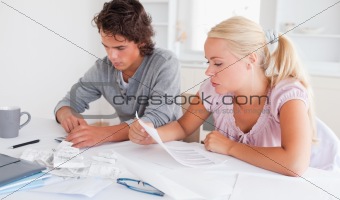 Worried cute couple accounting