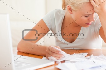 Sad blond woman accounting