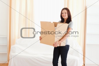 Woman carrying cardboard