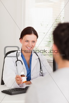 Female doctor showing pills