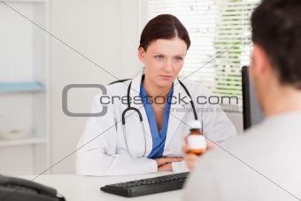 Female doctor and patient with pills