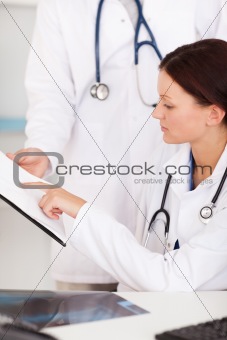 Female doctor pointing on file