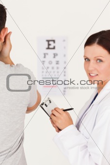 Female optician making notes