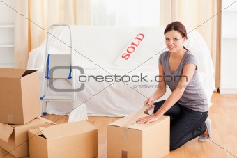 Female preparing cardboard box for transport