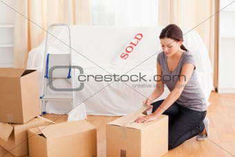 Female preparing cardboards for transport