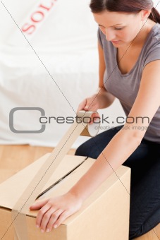 Woman preparing cardboard for transport
