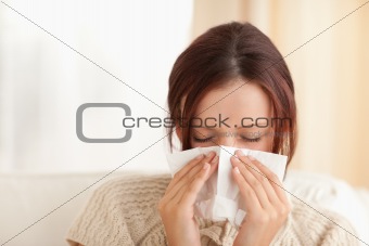 Sneezing cute woman