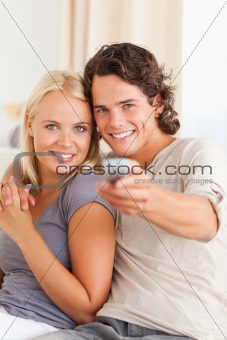 Portrait of a cute couple watching TV