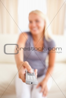Portrait of a smiling woman watching TV