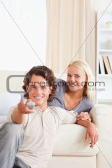 Portrait of a happy couple watching the television