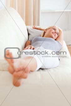 Portrait of a woman lying on a sofa