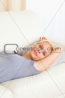 Portrait of a cute woman lying on a sofa