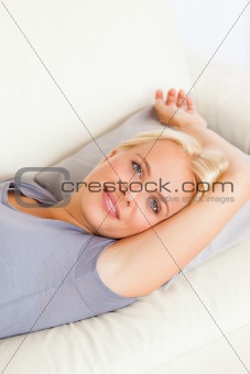 Portrait of gorgeous woman lying on a sofa