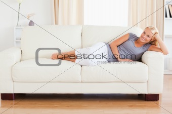 Blonde woman resting on a sofa
