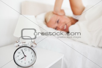 Angry woman awaken by her alarnclock