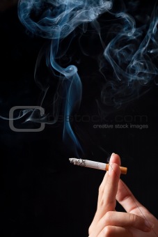 Hand with  smoking cigaret