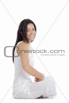 portrait of a woman sitting on the floor smiling - isolated on white