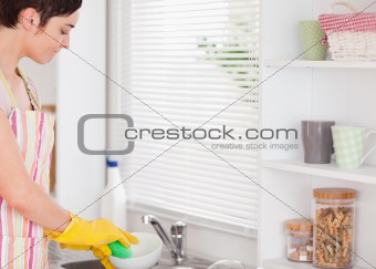 Beautiful woman washing the dishes