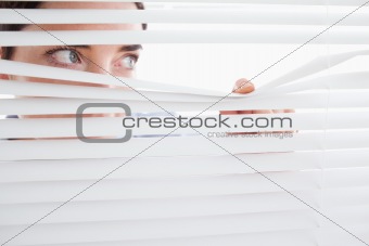 Woman peeking out of a window