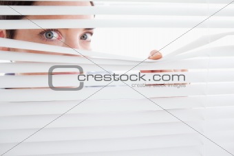 Beautiful Woman peeking out of a window