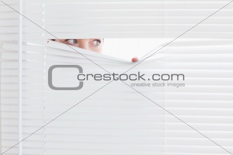 Businesswoman peeking out of a window