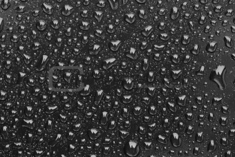 Rain droplets on a black plastic
