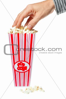 Hand grabbing popcorn out of container