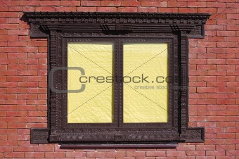 Brick wall and window with yellow blinds