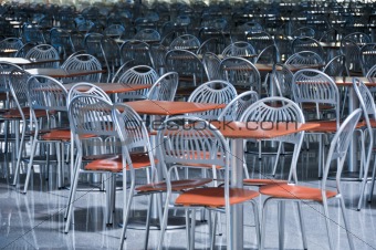 a lot of chairs and tables in fast food cafe