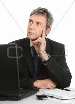 Thoughful business man working on laptop