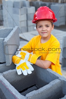 Boy learning the tricks of trade at a construction site